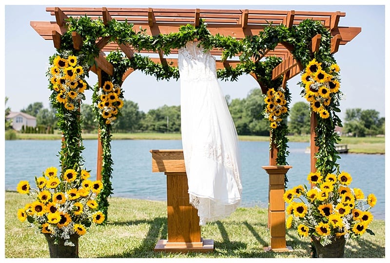 Wedding dress hanging in sunflowers
